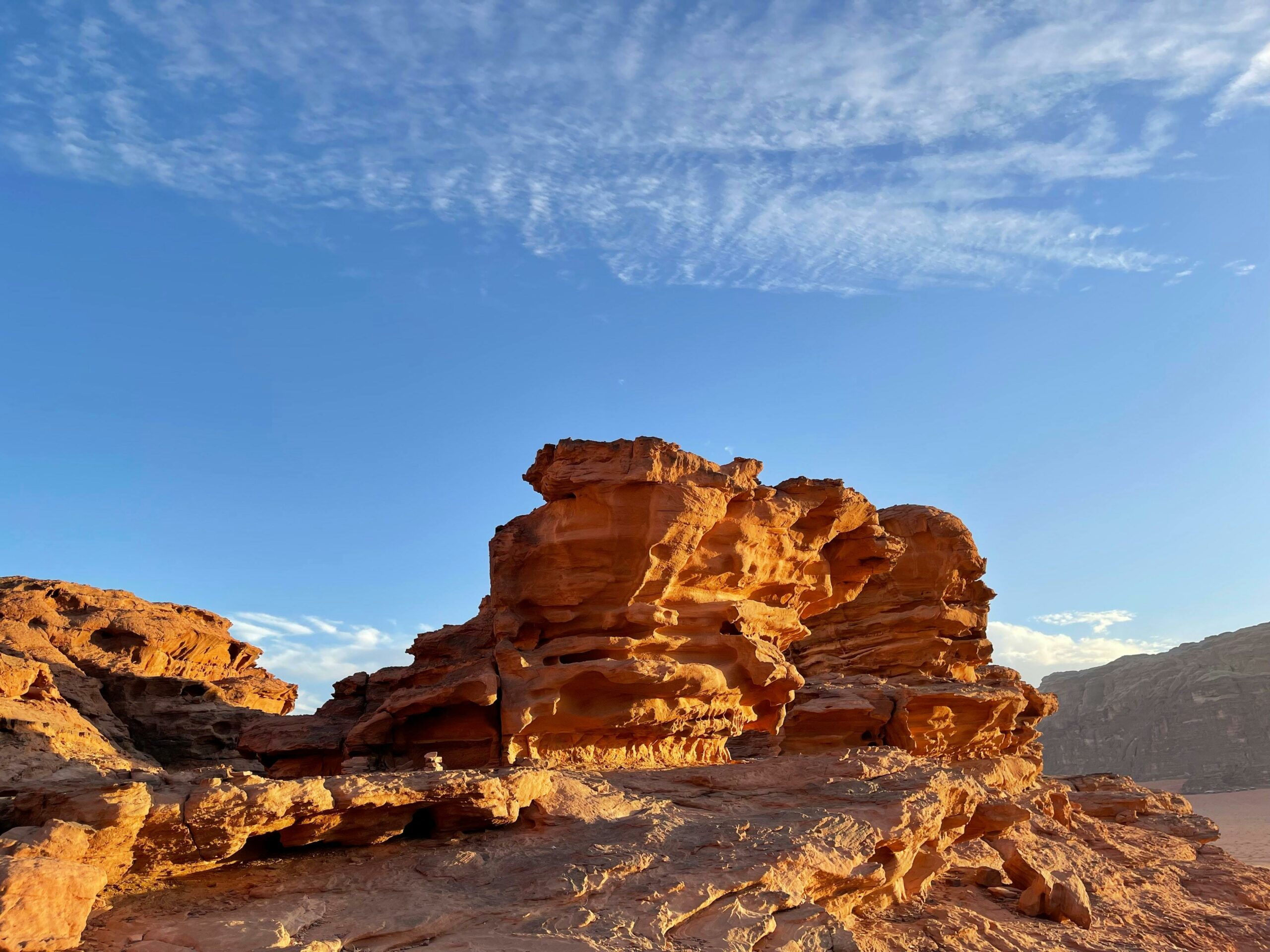 Majestic sandstone formations under a clear blue sky in Wadi Rum, Jordan.