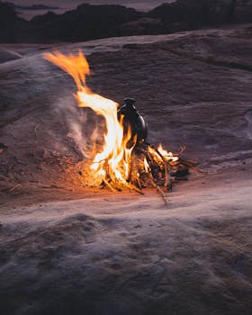 A small campfire burns warmth into the night in the desert landscape of Wadi Rum, Jordan.