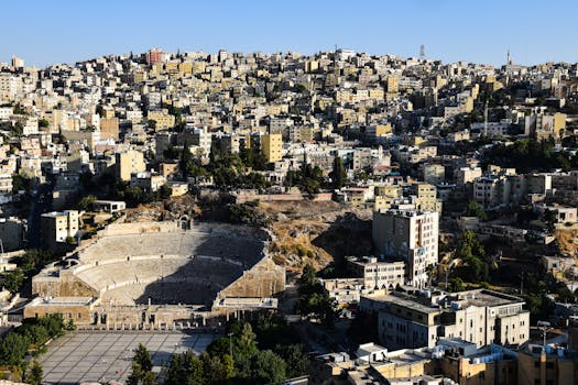 Explore Amman's iconic Roman Theater set amidst a sprawling urban landscape.
