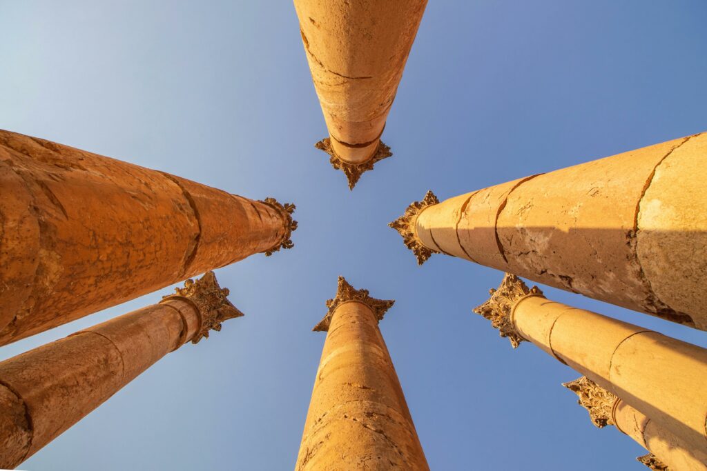 Stunning view of ancient Roman columns under a clear blue sky in Jerash, Jordan.